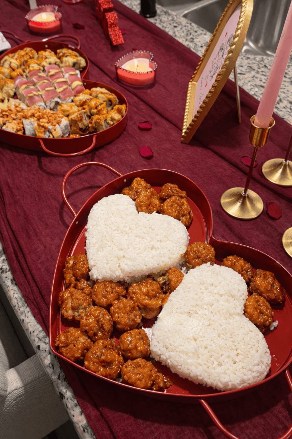 Heart-shaped rice and orange chicken Valentine's display
