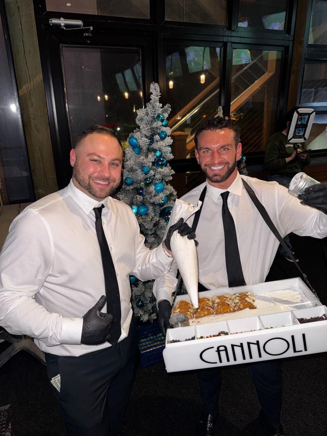 Mark and Tony serving cannoli