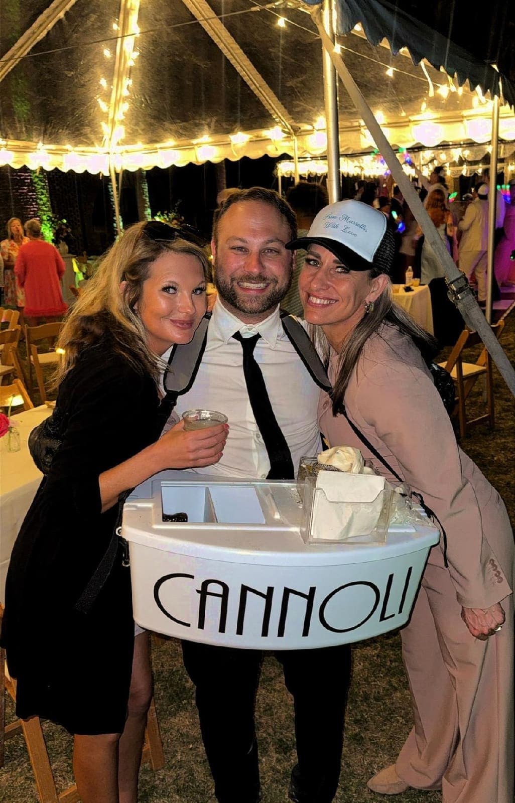 Cannoli server with guests at tent event