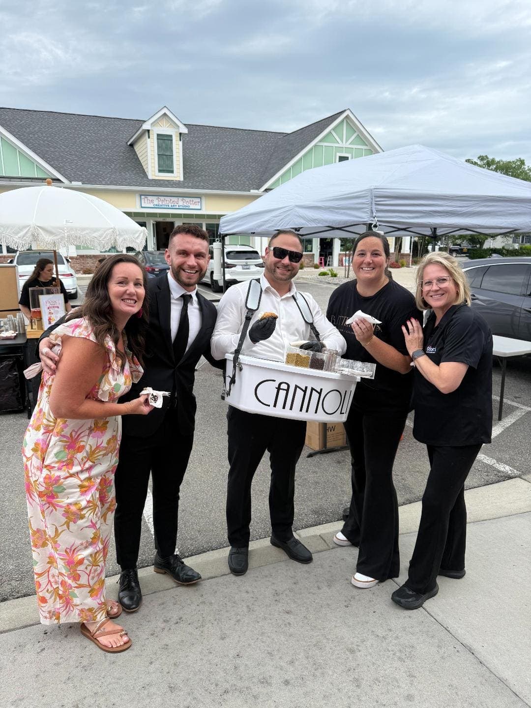 Group photo with cannoli server at outdoor event