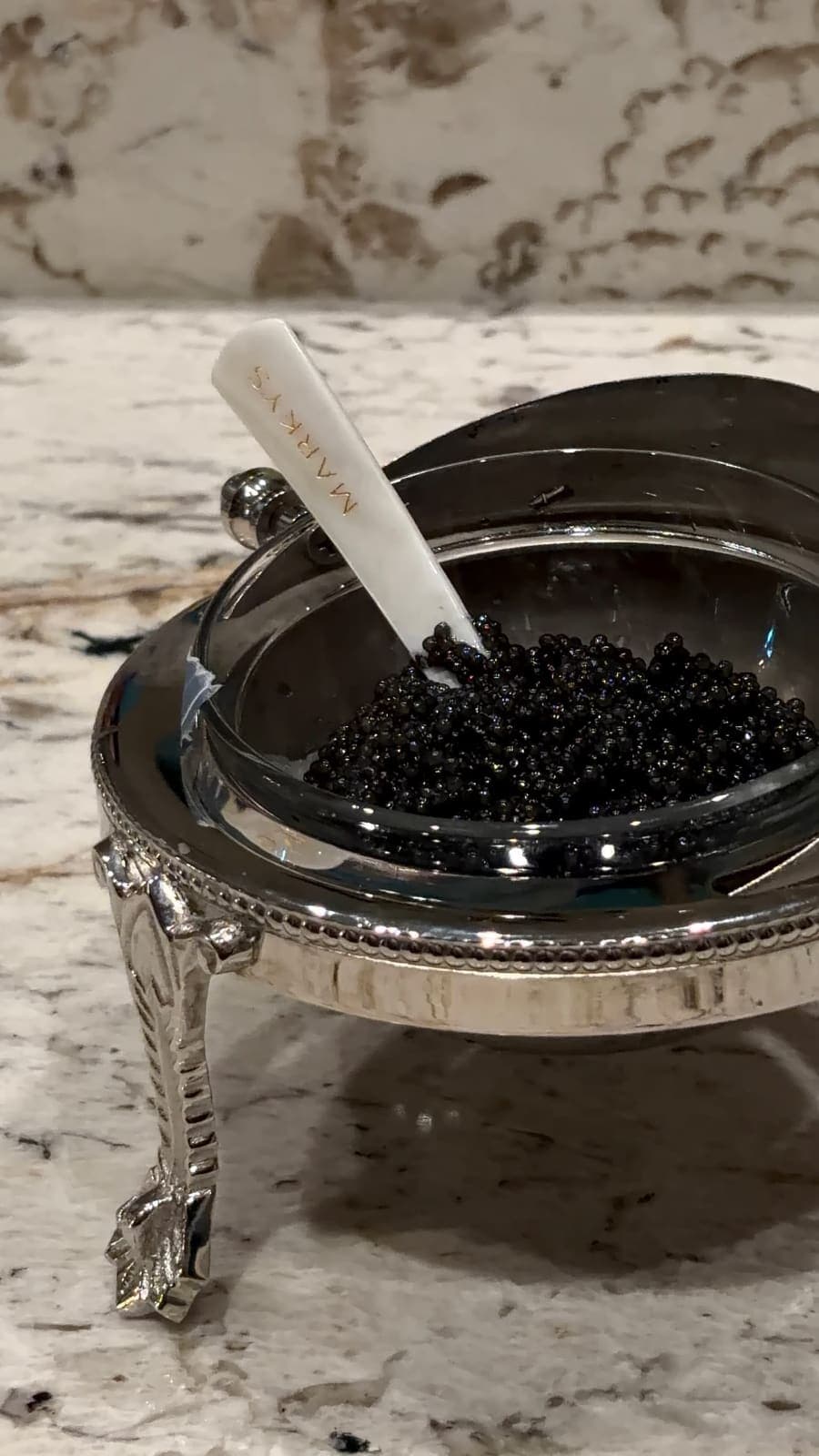 Caviar presented in an ornate silver footed serving dish