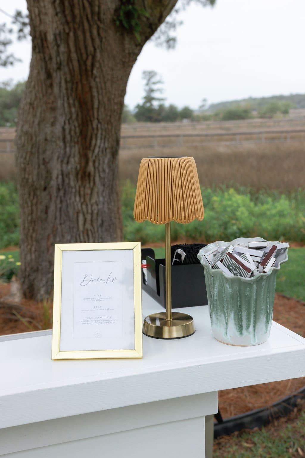 Framed drinks menu on an outdoor bar overlooking the marsh