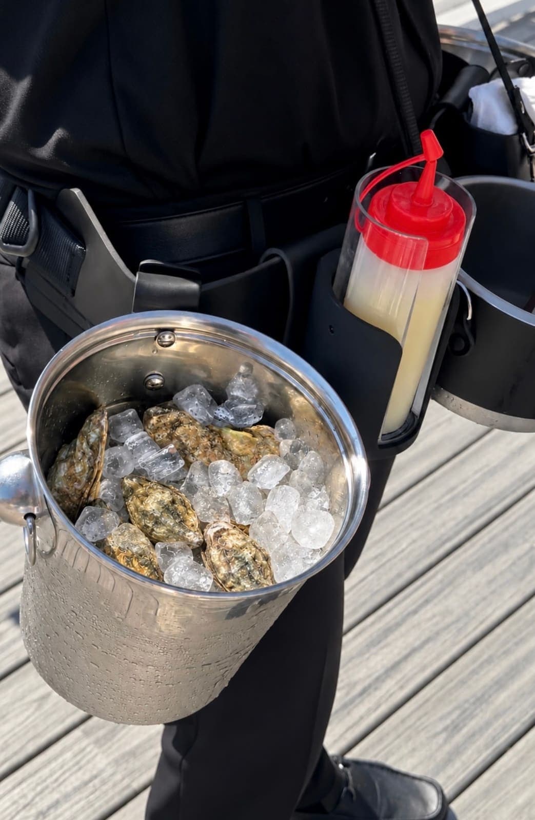 Close-up of the roaming oyster belt with fresh oysters on ice and mignonette
