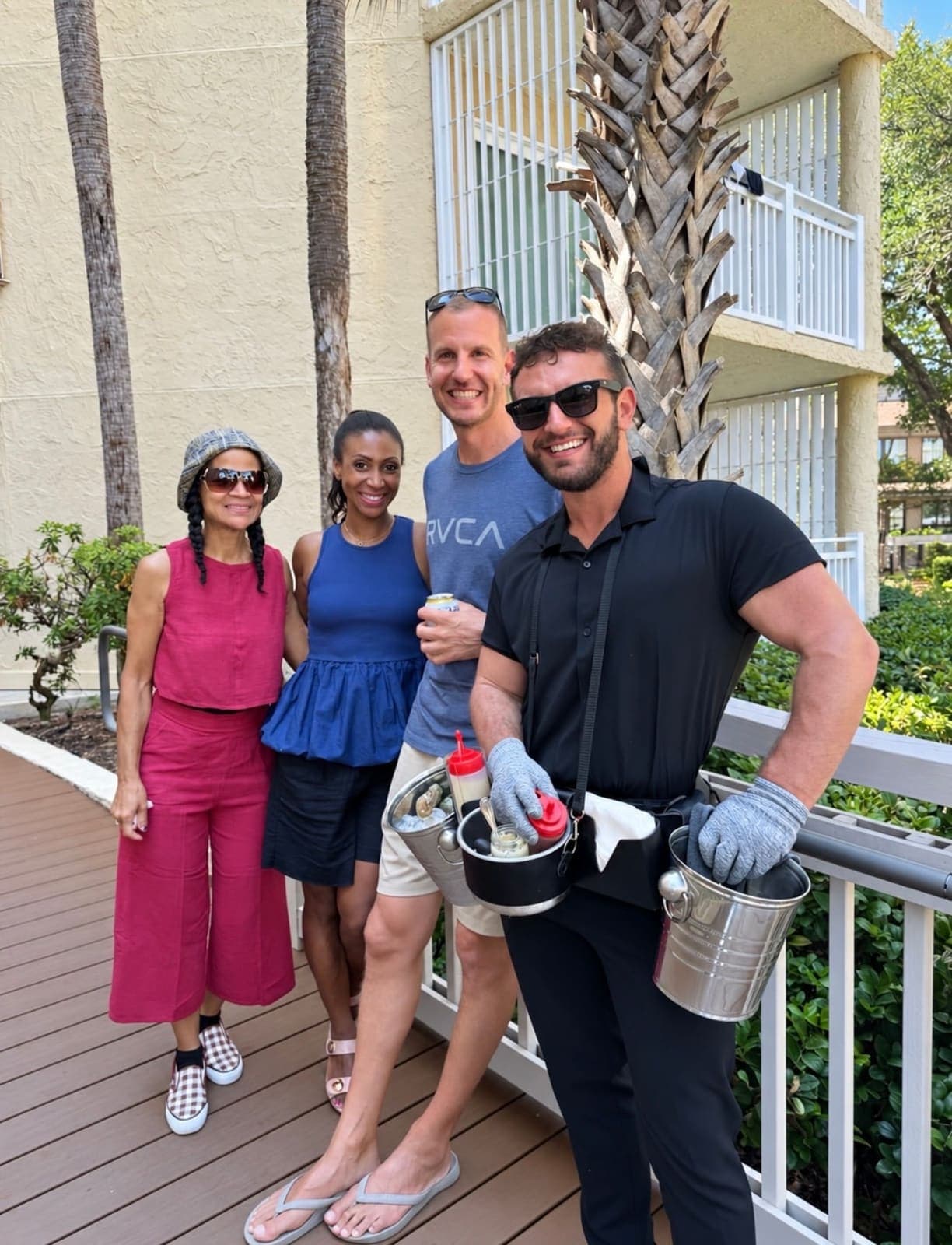 Guests posing with the roaming oyster attendant and his oyster belt