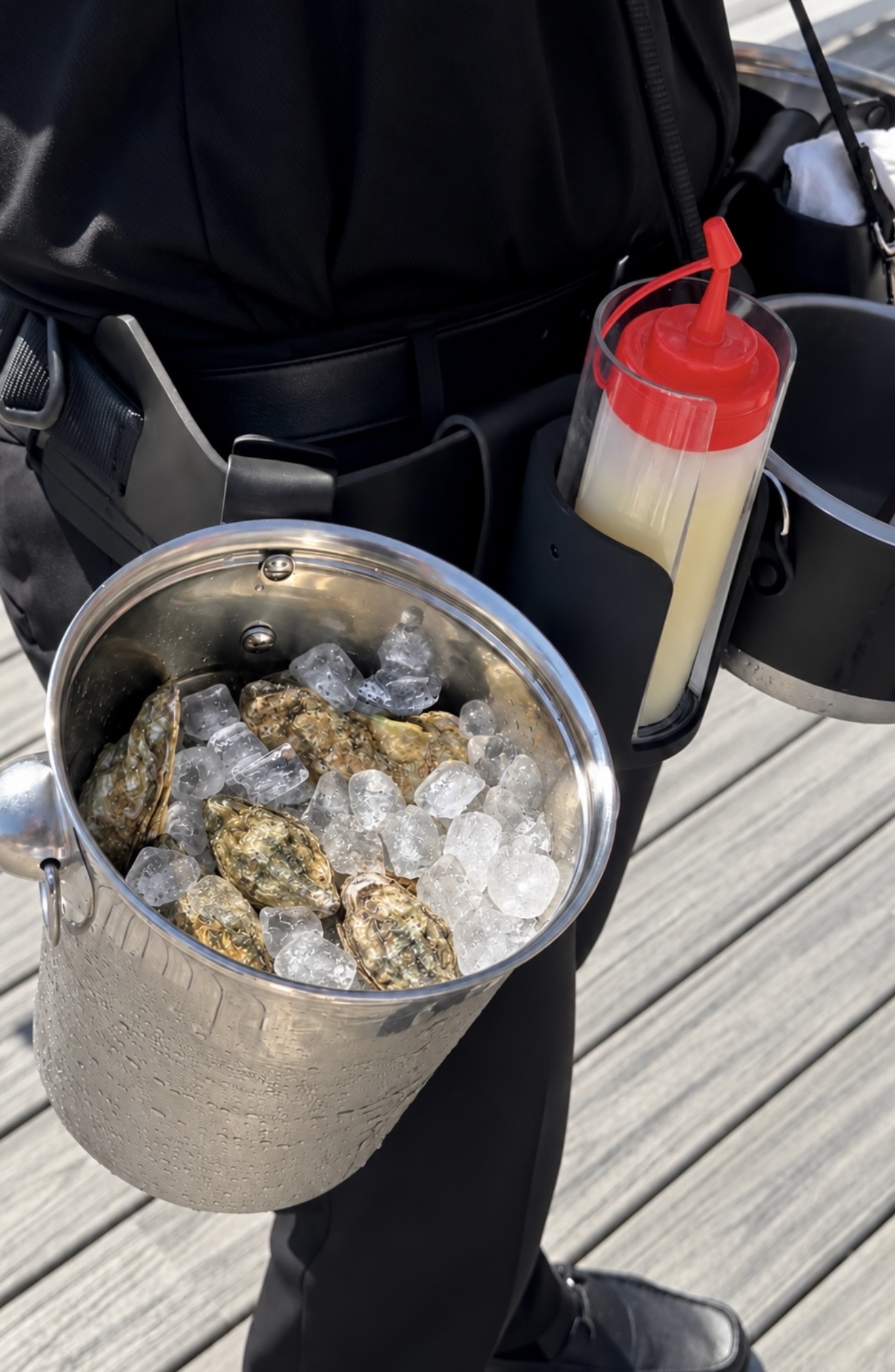 Close-up of the roaming oyster belt with fresh oysters on ice and mignonette